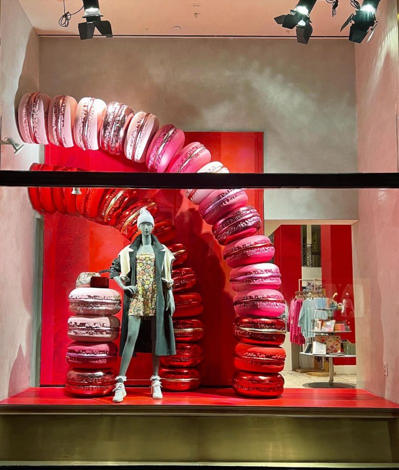 Anthropologie storefront window display featuring oversized red macaron sculptures