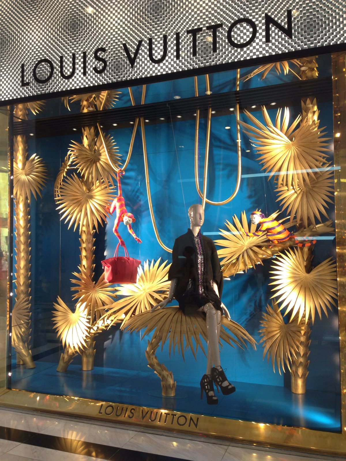 Louis Vuitton window display featuring large-scale paper sculpture installation
