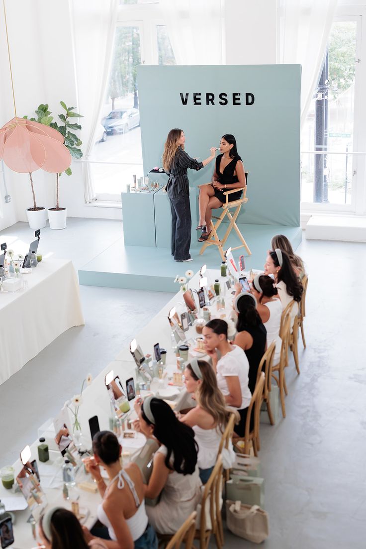 Versed skincare masterclass event with branded backdrop, long table setup, and live demonstration