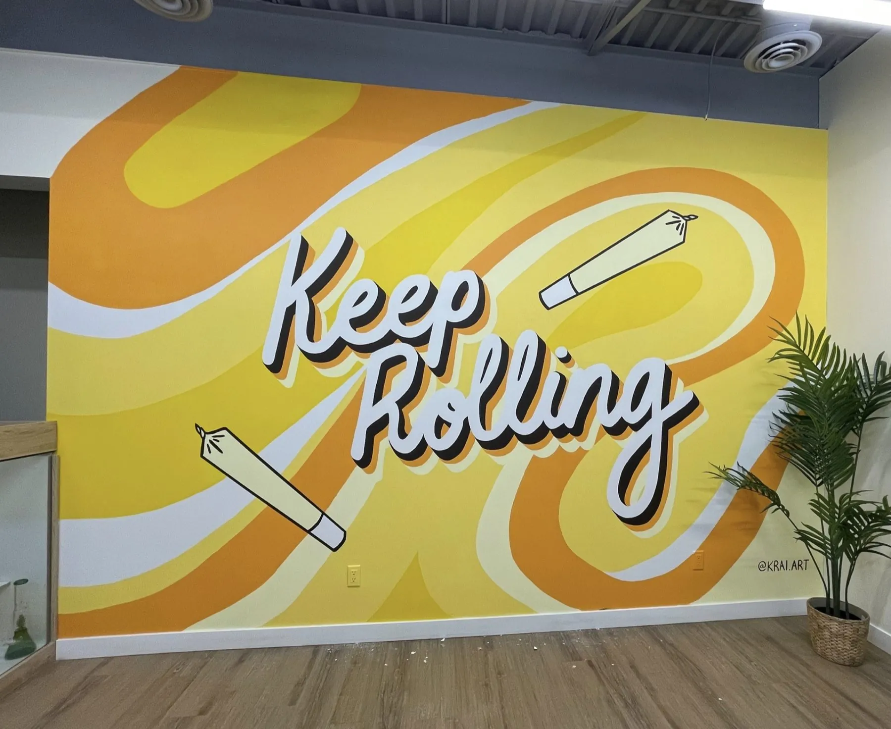Keep Rolling typographic retail mural for Bud Mart in Chestermere, by KINN Studios
