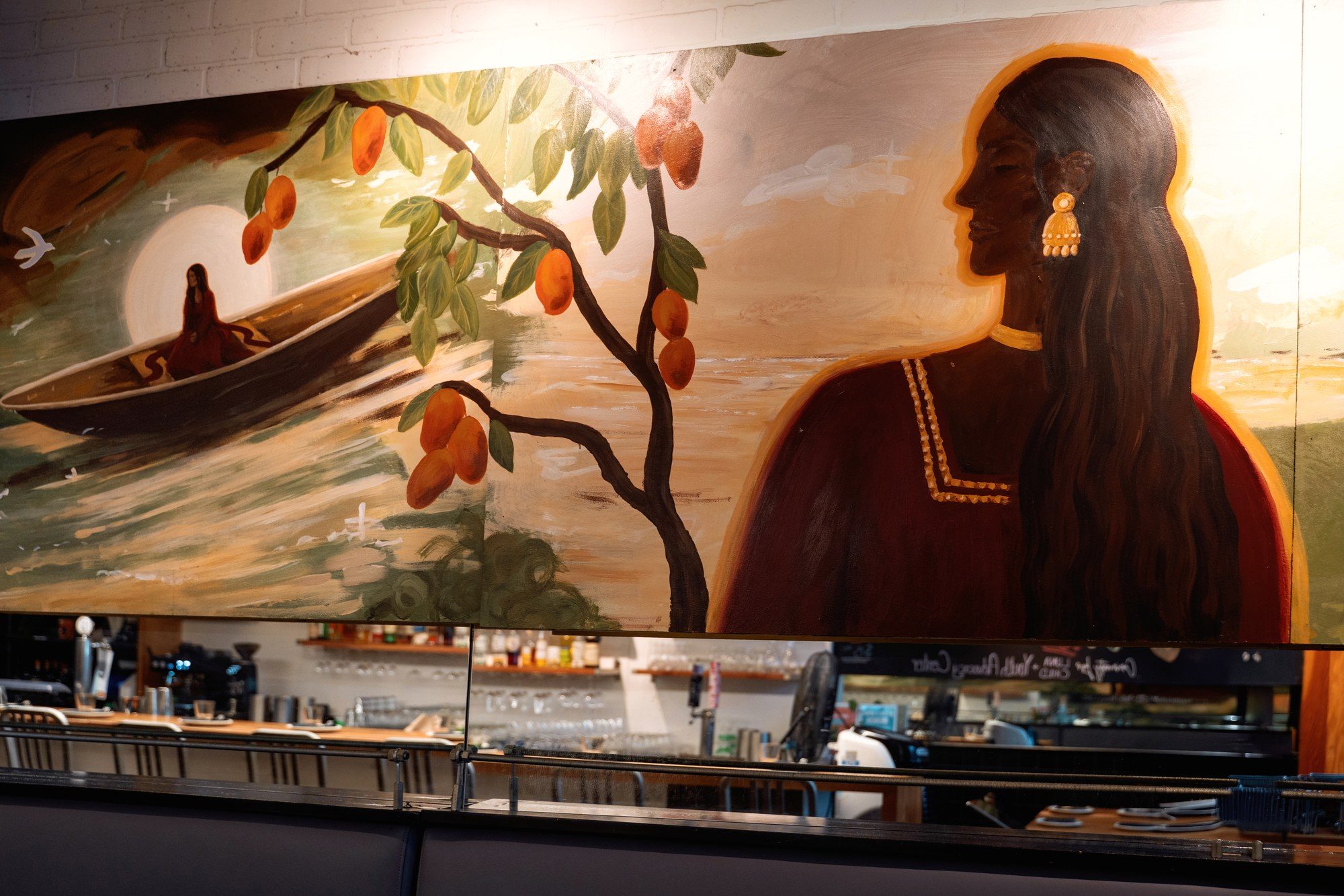 Detail of the UNA Pizza artboard: a woman in profile beside a mango branch in fruit and a figure in a boat