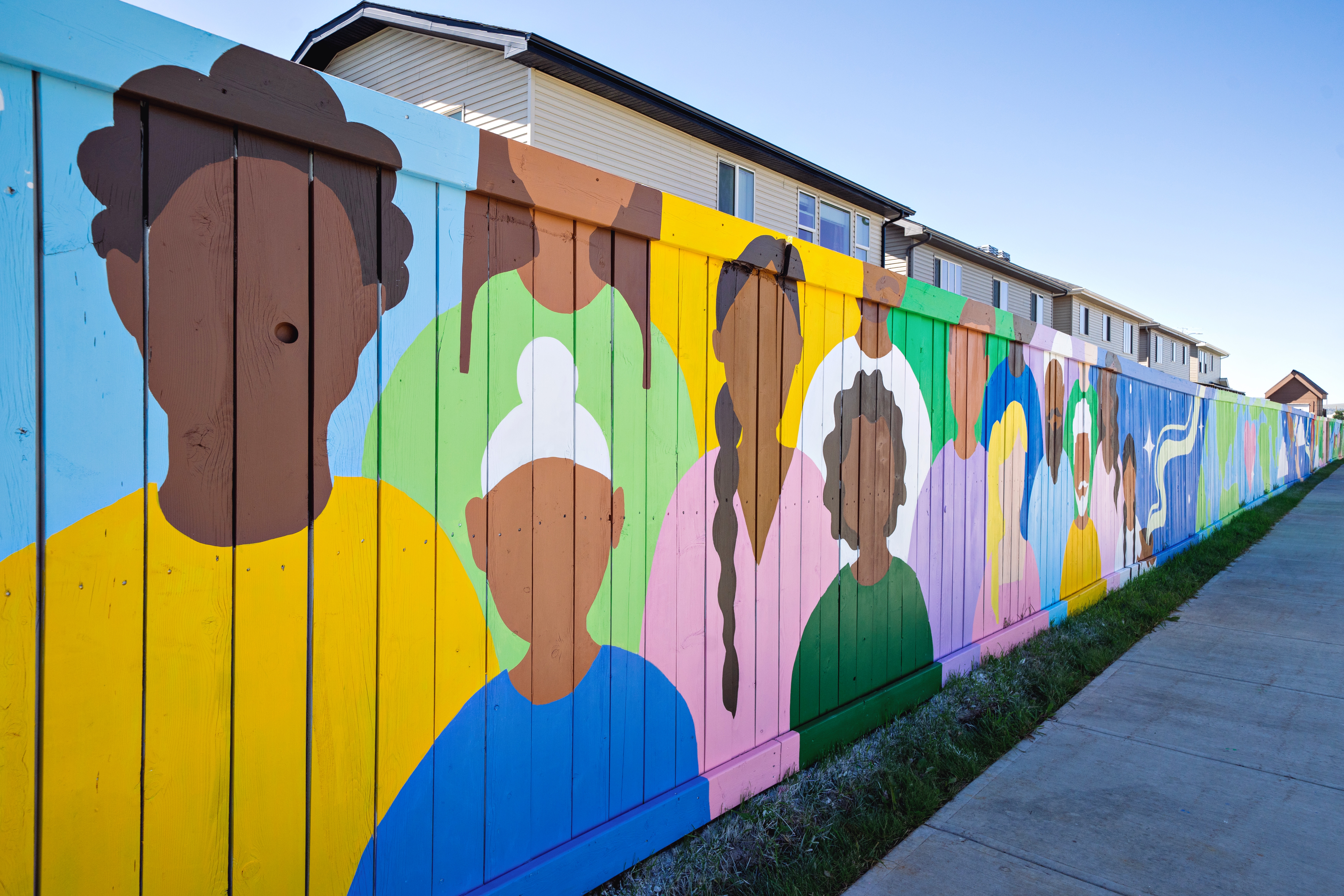 Silhouette figures representing Calgary's diverse communities, detail from the Vibrance in Diversity 100-metre exterior mural